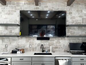 TV on brick wall with sound